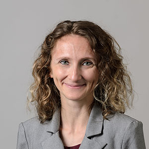 Caucasian woman in front of gray background